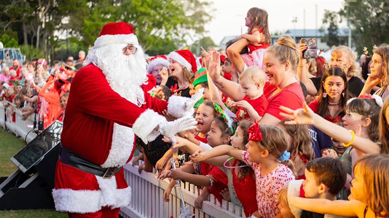 Santa greeting children and families in the audience
