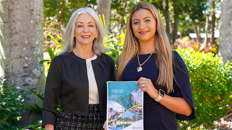 Cr Sara Souvlis and Cr Michelle Govers holding Fraser Coast Futures document