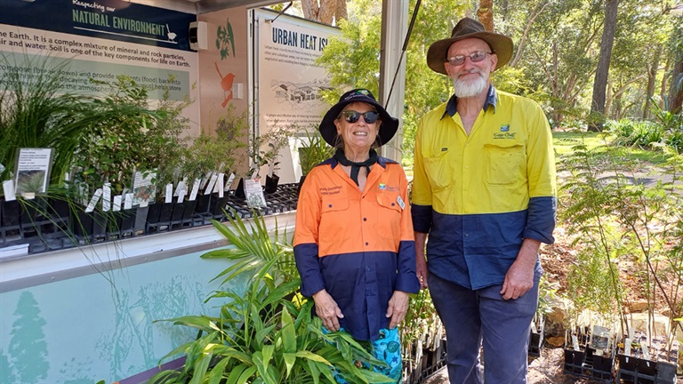 Staff and volunteer at the Hervey Bay Botanic Gardens with plant donation seedlings