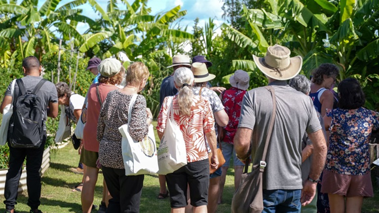 Group walking through lush garden