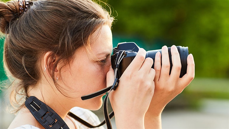 Young person taking photo with camera