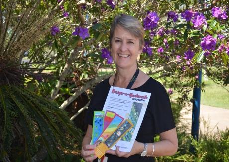 Fraser Coast Libraries programs and engagement assistant librarian Marianne Grimshaw shows last year’s winning bookmarks at the launch of this year’s Design-a-Bookmark competition.