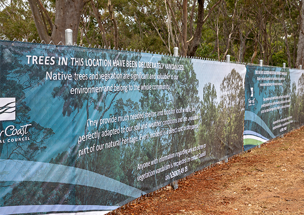 Fence and banner installed around poisoned trees