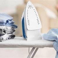 image of iron on ironing board plus clothes